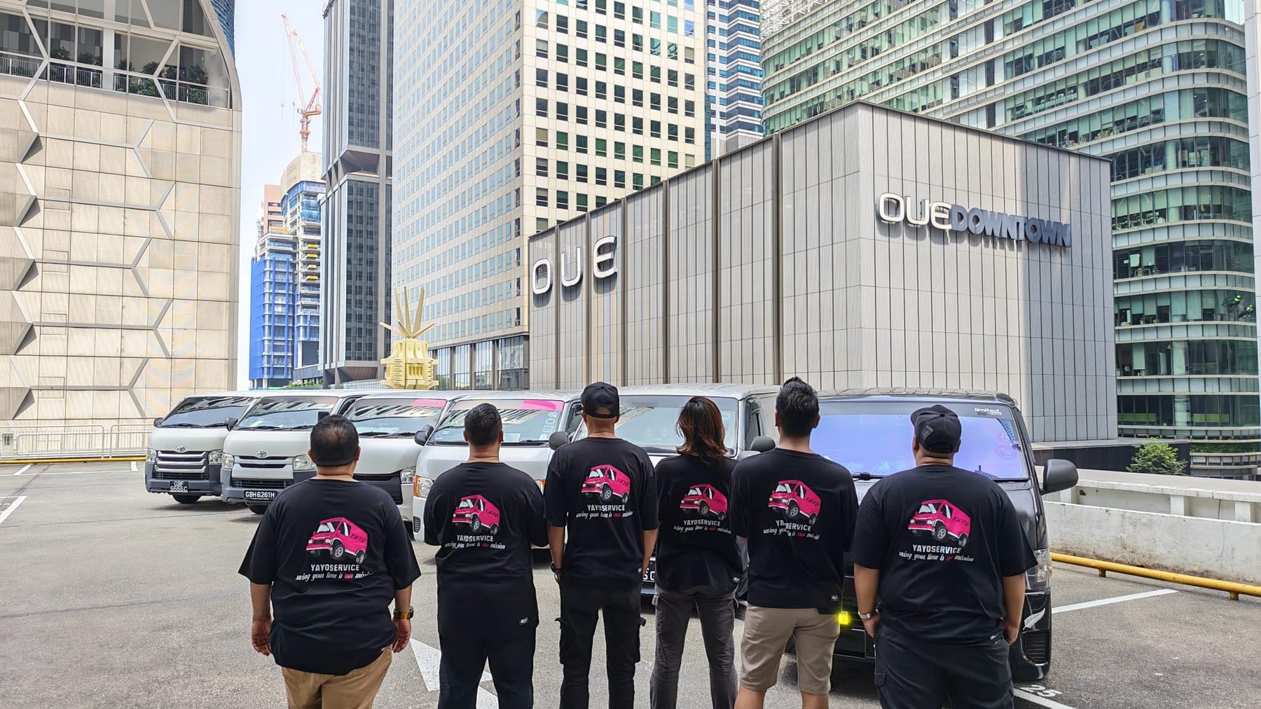 The Yayo Service crew reviewing the day's routes beside their fleet